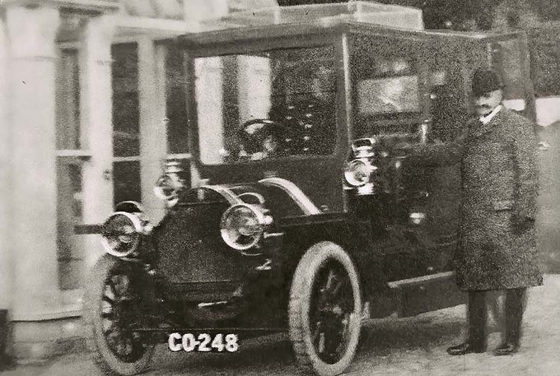 Vintage car outside Battiborough House with chauffeur